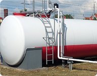 large white and red pressure vessel tank with a ladder on the side