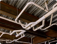 white pipes on a metal and wood ceiling